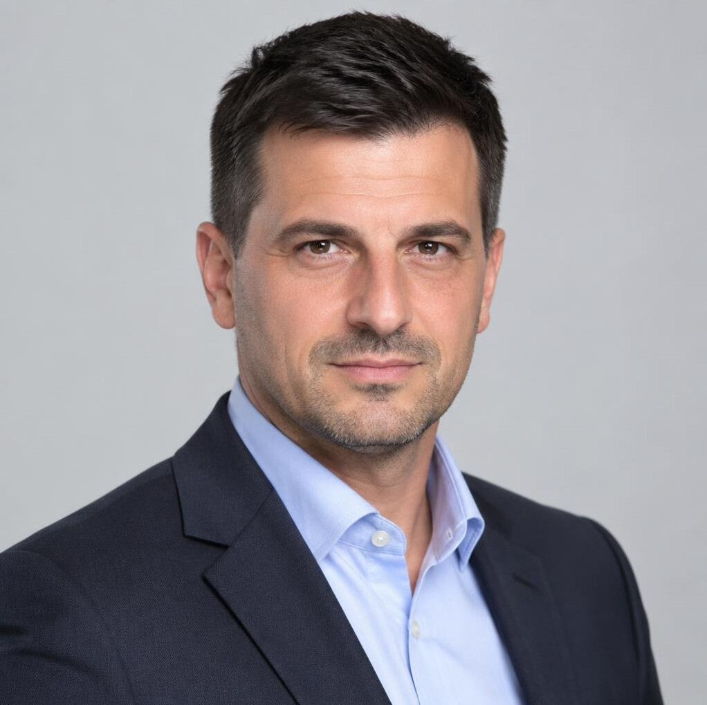 Studio portrait of a Croatian man in his 40s wearing a blazer